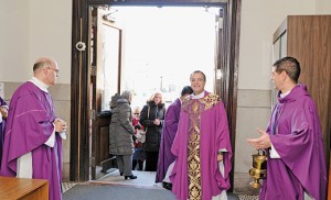On Dec. 20, Father John Vignone, Dean of the Atlantic County parishes, opened the Holy Door at Saint Nicholas of Tolentine Church, of Saint Monica’s Parish, Atlantic City, to mark the Jubilee Year of Mercy. Above, Father Vignone with Father Nicholas Dudo (left), pastor of Our Lady of Perpetual Help in Galloway, and Father Jon Thomas (right), pastor of Saint Monica. Below, priests and faithful gather outside the church. Photos by Alan M. Dumoff