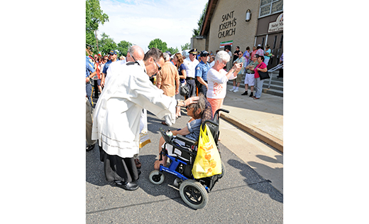 Father Joseph Capella blesses a woman at the Our Lady of Mount Carmel Festival in Hammonton in 2014. The priest is the pastor of Our Lady of Guadalupe Parish in Lindenwold, a diverse parish with a large number of Latino and Burmese members.

Photo by Alan M. Dumoff