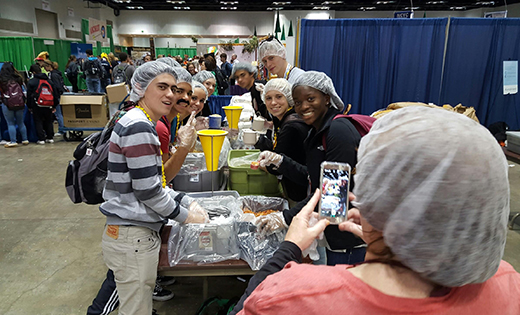 Youth make meals for the hungry.