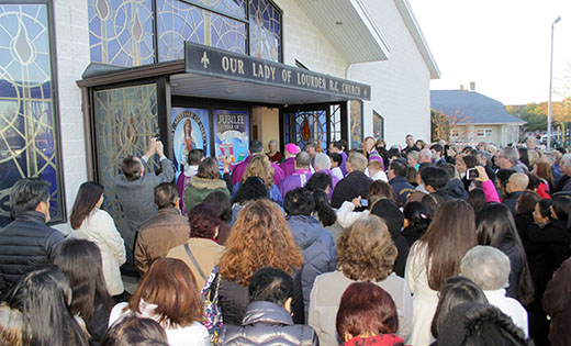 Bishop Dennis Sullivan opened the Holy Door at Mary, Mother of Mercy Parish in Glassboro before the 8 a.m. Mass on Sunday, Dec. 20. Bishop Sullivan also was present for the commemoration of the parish’s and Filipino Apostolate of South Jersey’s 20th anniversary of the Misa de Gallo Novena. Three other Holy Doors were opened later in the day at Our Lady Star of the Sea Church in Cape May, Parish of Saint Monica in Atlantic City, and Divine Mercy Parish in Vineland.

Photo by Mike Walsh