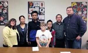 The refugee Po family from Myanmar (Burma) and the volunteer Rosvold family from Delran are pictured at the Catholic Charities office in Camden. The Rosvold’s youngest son, Luke, aged 12, was born with a cleft palate and has been through 11 surgeries. The Po’s son Joseph, 9, was also born with a cleft palate and had surgery soon after this photo was taken. The two families met to talk about what to expect during and after the surgery. Pictured from left: Jill Rosvold (Luke’s mother), Me Meh (Joseph’s mother), Po Reh (Joseph’s father), Luke Rosvold, Joseph Po, Thing Mangshang (Catholic Charities case worker aide), and Bob Rosvold (Luke’s father). Photo courtesy of the Rosvold family