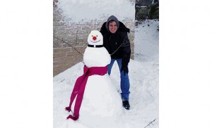 Seminarian Josh Nevitt from Saint Andrew the Apostle Parish, Gibbsboro, stands by a snowman wearing a Roman collar.
