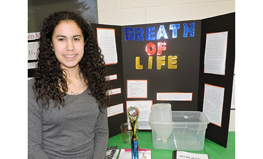 Rosemarie Beyers, an eighth grader from Mays Landing, stands by her project, “Breath of Life,” at the Saint Vincent de Paul School science fair.