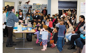 Children enjoy a presentation of “Bubble Magic,” the science of bubbles, from the Garden State Discovery Museum. The presentation was part of a program for refugee families and their neighbors, hosted by Catholic Charities at its Camden office. Photo by James A. McBride