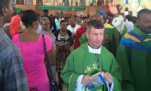 Father Joseph D. Wallace, pastor of Notre Dame de la Mer Parish, at the end of Mass in Haiti.
