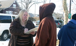 Cindy Lebron of Catholic Charities gives a survey to a homeless man outside a soup kitchen in Vineland during Cumberland County’s annual Point In Time survey of the homeless. Photo by Joanna Gardner