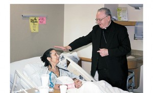 Bishop Dennis Sullivan blesses Linda Mackay of Williamstown during his visit to Kennedy Hospital on Feb. 11, World Day of the Sick. Photo by Mike Walsh