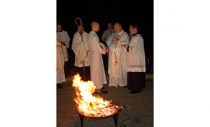 Bishop Dennis Sullivan leads the faithful in worship before the “blazing fire” (rogue ardens), dispelling the darkness, at the Easter Vigil in Mullica Hill, at the Catholic Community of the Holy Spirit on March 26.