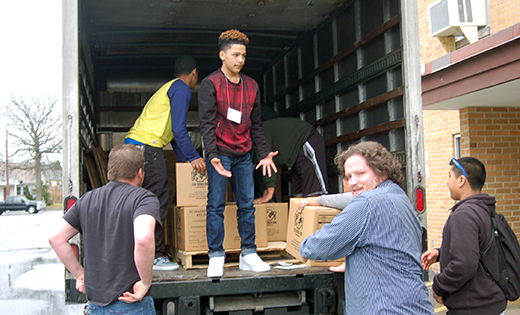 Above, youth load a truck of meals, prepared and boxed up, at the Diocesan Youth Congress in Vineland. Below, the meal-making operation.

Photos by James A. McBride