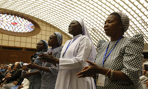 Nuns sing as they wait for Pope Francis’ arrival at an audience with the heads of women’s religious orders in Paul VI hall at the Vatican May 12. During a question-and-answer session with members of the International Union of Superiors General, the pope indicated his willingness to establish a commission to study whether women could serve as deacons. (CNS photo/Paul Haring)