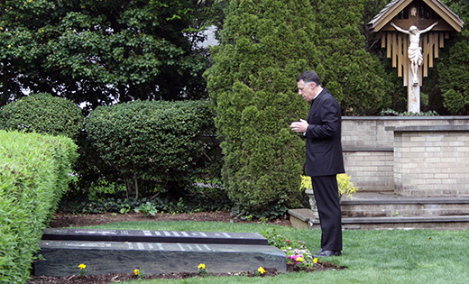 Bishop James F. Checchio prays at the graves of deceased bishops of Metuchen before evening prayer at the Cathedral of Saint Francis of Assisi, Metuchen, on May 2. Left Bishop Checchio processes into the cathedral. The next day, May 3, he was installed as the fifth bishop of the diocese in the Church of the Sacred Heart, South Plainfield.