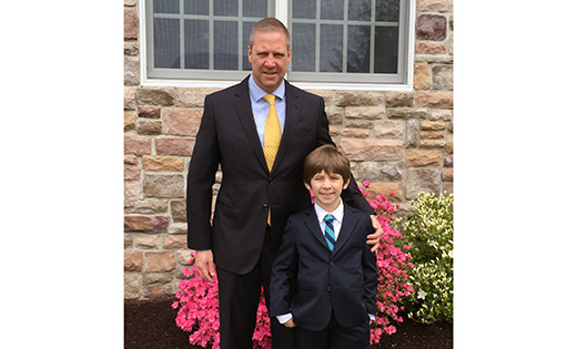 Eric Reich and his son C.J. pose for a photo on the day of C.J.’s first Communion at Saint Maximilian Kolbe Parish in Marmora. Eric received his first Communion about a month earlier.