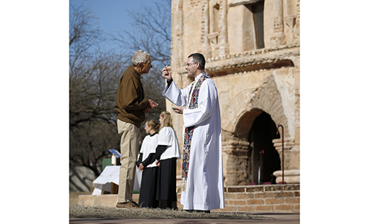 Jesuit Father Sean Carroll gives Communion during Mass at Tumacacori National Historical Park in Tumacacori, Ariz., Jan. 10. The service was part of the park’s Kino Legacy Day, paying homage to Father Eusebio Francisco Kino and his contributions to the Pimeria Alta region, now northern Sonora, Mexico, and southern Arizona. Father Carroll is director of the Kino Border Initiative, a binational organization serving and advocating for migrants.

CNS photo/Nancy Wiechec