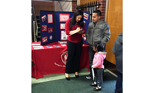 Marianela Nuñez, Field Consultant for the Latino Enrollment Initiative, speaks with a Hispanic family about Saint Michael the Archangel Regional School at Saint Bridget Parish, Glassboro. Currently, only about 3 percent of Hispanic children attend Catholic schools nationally. In the Diocese of Camden about 10 percent attend Catholic schools.