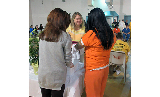 Prison ministry volunteers from the Church of St. Andrew the Apostle in Gibbsboro wash the hands of an inmate during a Holy Thursday Mass in 2015. With her back turned is volunteer Chris Parry, facing the inmate is volunteer Catherine Rossignol.

Photo by Joanna Gardner