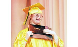 Tricia Flynn holds her diploma during commencement exercises at Archbishop Damiano School, Westville Grove, on June 14. This year six students graduated from the school that educates children with moderate to severe cognitive disabilities.