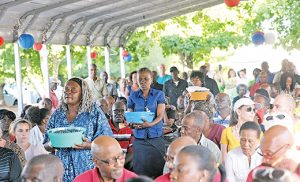 Worshippers carry baskets of blueberries (right) in the offertory procession during the sixth annual Mass of recognition for Haitian Farmworkers. It was celebrated the evening of June 17, in both Haitian Creole and English, at Columbia Fruit Farm on Columbia Road in Hammonton. The main celebrant was retired Auxiliary Bishop Guy A. Sansaricq of Brooklyn. A reception followed the Mass. Photo by Alan M. Dumoff