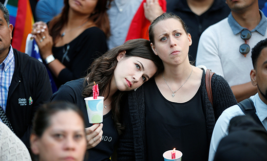 Women hold candles during a June 13 vigil in Los Angeles for the victims of the mass shooting at the Pulse gay nightclub in Orlando, Fla. A lone gunman, pledging allegiance to the Islamic State terrorist group, killed 49 people early June 12 at the nightclub.

CNS photo/Lucy Nicholson, Reuters