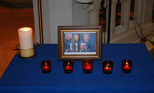 Five votive candles burn in the Cathedral of the Immaculate Conception, Camden, in memory of the five police officers who were killed by snipers at a demonstration in Dallas to protest the police killing of black men in Baton Rouge, La., and a suburb of St. Paul, Minn. To the left of the five, a single white candle burns in memory of all who have been killed by violence.

Photo by James A. McBride