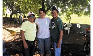 Author Catherine Buck, who recently spent four months in Chacraseca, Nicaragua, is pictured with locals Juan Pablo Membreño, who works as a bus driver, and Alfredo Blanco, a translator. Below, outside the Casa de Paz, or Peace House, built through the ministry of a Maryknoll sister.