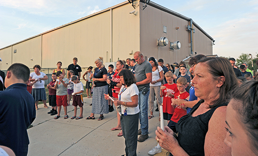 The school community of Saint Michael the Archangel participates in a candlelight prayer service on Sept. 9.

Photo by Alan M. Dumoff