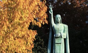 A splash of autumn color is seen next to the statue of Christ outside the headquarters of the U.S. Conference of Catholic Bishops in Washington in this photo from November 2011. CNS photo/Nancy Phelan Wiechec