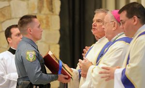 The 15th annual Blue Mass, honoring law enforcement officers, firefighters and emergency responders serving in the six counties of the Diocese of Camden, was celebrated Sept. 28 at Blackwood’s Our Lady of Hope Parish. Bishop Dennis Sullivan was the principal celebrant. Above, the bishop is assisted by Investigator Michael Perez of the Voorhees Police Department, and Deacons Michael Hogan and Aaron Smith. Photos by Mike Walsh