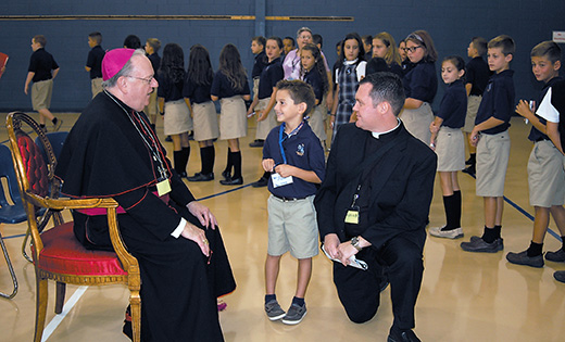 Saint Mary Regional School first grader Patrick McGrory greets Bishop Dennis Sullivan during the Camden leader’s visit to the Vineland school on Sept. 7, the second day of classes. Pictured at right is Father Michael M. Romano, secretary to the bishop.

Photo by James A. McBride