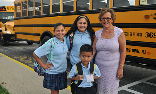 Standing in front of the buses at Saint Mary School, Williamstown, are principal Patricia Mancuso, fifth grader Nola Byrne, seventh grader Keeley Byrne and first grader Alexander Cunanan.