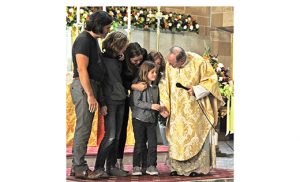 David Bowers, 6, with his mother, Michelle; family members; and Father Tim Byerley, thank the faithful at Saint Peter Church for their prayers during the Merchantville parish’s annual 40 Hours devotion, which took place from Sunday, Oct. 9 to Tuesday, Oct. 11. The three days focused on Servant of God Maria Esperanza, chief visionary of the Marian apparitions in Betania, Venezuela, when Our Lady identified herself as Mary, Virgin and Mother, Reconciler of All Peoples and Nations. On Oct. 9, Michelle Bowers spoke of how her son David was healed through the intercession of Maria Esperanza. Father Byerley, pastor at Saint Peter’s, is the vice-postulator for the canonization cause of the Servant of God. Photo by Alan M. Dumoff