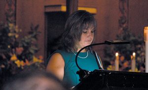 Kim McLaughlin reads Bishop Dennis Sullivan’s letter proclaiming the name of Saint Teresa of Calcutta Parish, Collingswood, on Oct. 2, the day the parish celebrated its change from “Blessed Teresa” to “Saint Teresa.” Bishop Dennis Sullivan was the principal celebrant. Pope Francis canonized Mother Teresa on Sept. 4. Photo by James A. McBride