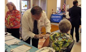 Pharmacist Allan Ginsberg administers a flu shot during the Healthy Aging and Wellness Fair sponsored by VITALity Catholic Healthcare Services Sept. 24 at Haven House in Cape May.