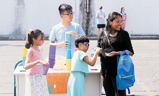 Refugee children count the tickets they won during a cup-stacking game, which they then exchanged for prizes donated by parishes, individuals and volunteers. Fifty families attended the Mother Teresa Day of Service — all of whom walked away with prizes and a closer connection to the community.