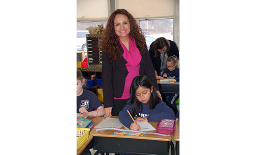 Claudia Trani-Melgar, Spanish teacher and “Madrina” at Guardian Angels Regional School, helps second grader Samantha Vicente Matteo with her vowel patterns recently at the Gibbstown campus.
Photo by James A. McBride