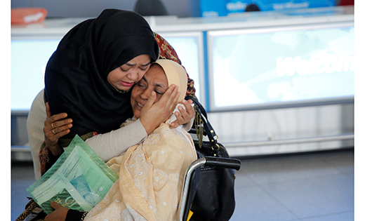 A woman greets her mother after she arrived from Dubai at John F. Kennedy International Airport in New York City Jan. 28. 
CNS photo/Andrew Kelly, Reuters