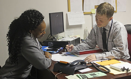 John Seibel of Catholic Charities works with his client, Ashley Harvey, on closing her case file after working with her for the past 12 months to help her establish a stable home, job and budget.

Photo by Mary McCusker