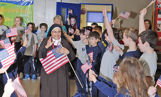 Sister Nabila Abdel-Malak Gerges is congratulated by students of Saint Michael the Archangel School, Clayton, on March 29, the day after she became an American citizen.

Photo by Alan M. Dumoff
