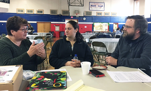 Elementary school teachers discuss Motivator Maps, an interdisciplinary approach to learning. Pictured from left are Cecelia Richard (Our Lady of Mt. Carmel); Jennifer Vidal and Brian Wolf (Saint Mary, Williamstown).