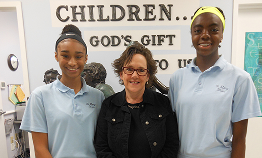 The Black Catholic Ministries scholarship winners are pictured with their elementary school principals. Above, Saint Mary School, Williamstown, principal Patricia Mancuso stands with Sidney Prescott, left, and Janice Ashong. Below, Saint Michael the Archangel, Clayton, principal Janice Bruni with Giselle Williams.