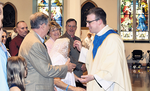 Newly-ordained Father Adam Cichoski greets his parents, Sharon and Frank, and other family members, at his ordination Mass, held May 20 at Camden’s Cathedral of the Immaculate Conception.

Photo by James A. McBride