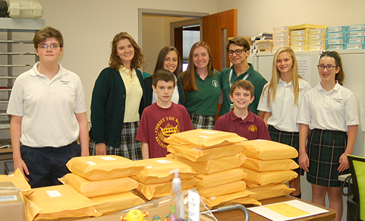 Catholic school students stand with envelopes full of letters set to be mailed to New Jersey legislators in October 2016. Requests for increased funding for transportation and school security in the 2018 state budget paid off.

Photo by James A. McBride