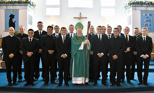 Above, Bishop Dennis Sullivan and new candidates gather for a photo with all of the seminarians of the Diocese of Camden after celebrating the annual Mass for new candidates at Our Lady of the Angels Church in Cape May Court House on Aug. 13. The diocese currently has the highest number of men studying for the priesthood in more than a decade. Below, the bishop stands with Thomas Piro, left, and Nick DiMunzio. Piro and DiMunzio will be entering Saint Andrew College Seminary, Seton Hall University, East Orange, in the fall.

Photos by James A. McBride