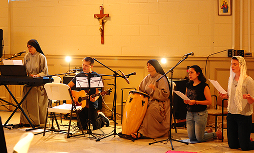 Sister Chiara and Sister Agnes, with Jeffrey Shields, Jessica Gettings and Jen Oliver, bring their musical talents and voices to Atlantic City’s Quaremba Hall last week, leading diocesan youth in adoration before the Blessed Sacrament.