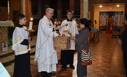 Father Vince Guest, pastor of Our Lady of Guadalupe, Lindenwold, blesses petitions at the parish’s monthly bilingual Mass in honor of Our Lady of Guadalupe on Sept. 12. The Mass included prayers for families that could be affected by President’s Trump’s decision to end the Deferred Action for Childhood Arrivals (DACA) program.

Photo by James A. McBride