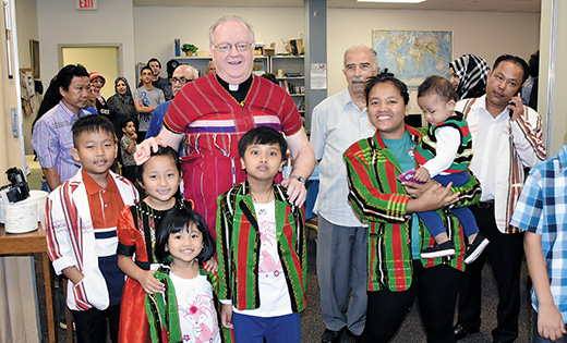 Bishop Dennis Sullivan poses with a family at the launch of the “Share the Journey” campaign at the Catholic Charities Office in Camden on Sept. 27. “Share the Journey” is a two-year campaign sponsored by Caritas Internationalis, the global network of national Catholic Charities — including the U.S. Catholic Relief Services and Catholic Charities USA — to promote encounters between people on the move and people living in the countries they are leaving, passing through or arriving in.

Photo by James A. McBride