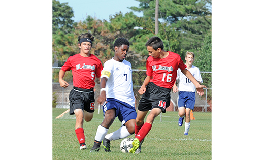On Sept. 22, the visiting Saint Joseph boys’ soccer team (Hammonton) defeated Holy Spirit 3-2 in Absecon. Above, Holy Spirit’s De-Quawn Johnson (7) fights with Saint Joseph’s Matt Bispo (16) for possession.
Photo by Alan M. Dumoff