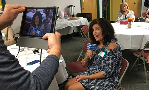 Diane Gallagher, advancement director from Good Shepherd School in Collingswood, helps with a demonstration of Facebook Live during a session led by Jackie Kern (Saint Mary’s Williamstown) and husband Joe Kern, a news director with KYW-TV in Philadelphia. The session was part of a gathering of advancement directors at Saint Margaret Regional School, Woodbury Heights.