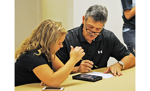 A man takes notes on paper as Angelina Chickelero, an eighth grade religious education student, teaches him some things he didn’t know about his smartphone. Our Lady of Peace Parish, Williamstown, sponsored a “Tech Night” on Oct. 18, matching technically challenged adults with tech-savvy students.

Photo by Alan M. Dumoff