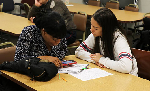 A bilingual Gloucester Catholic High School student tutors an asylee from Haiti who is learning English during one of the school’s visits to Catholic Charities, where the students eagerly engaged in volunteer work and service projects.

Photo by Mary McCusker
