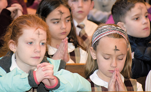 Above, Sophia Villano of Christ the King Regional School, Haddonfield, prays after receiving ashes during the school Mass. Left, Bishop Dennis Sullivan began the 40 Days of Lent with a distribution of ashes at Camden’s Cathedral of the Immaculate Conception. Calling this season a “spiritual springtime,” he urged all to “raise yourself for better Christian living, as Jesus raised himself” at Easter.

Photo above by Cynthia Soper, below by James A. McBride